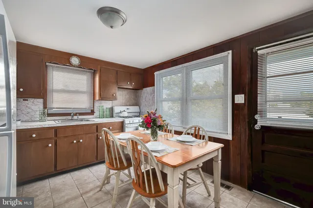 a kitchen with granite countertop a sink and cabinets