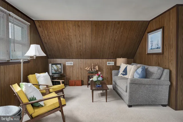 a living room with furniture and a lamp