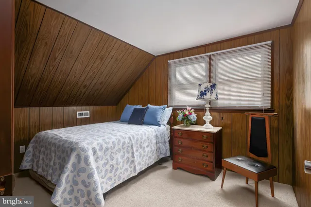 a bedroom with a bed and windows