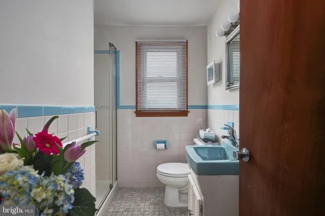 a bathroom with a toilet sink and mirror