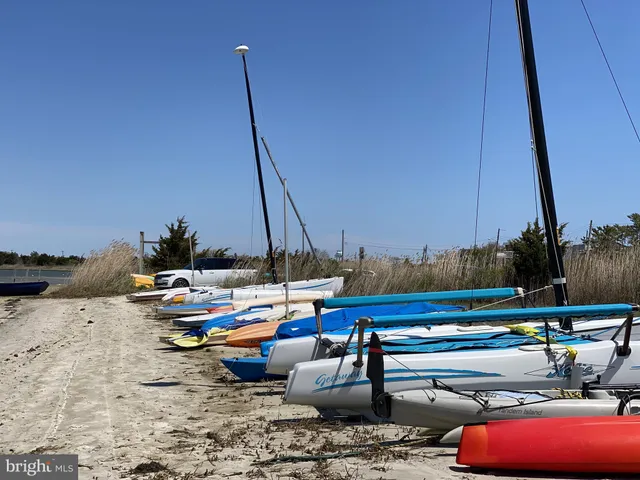 a view of swimming pool with lawn chairs