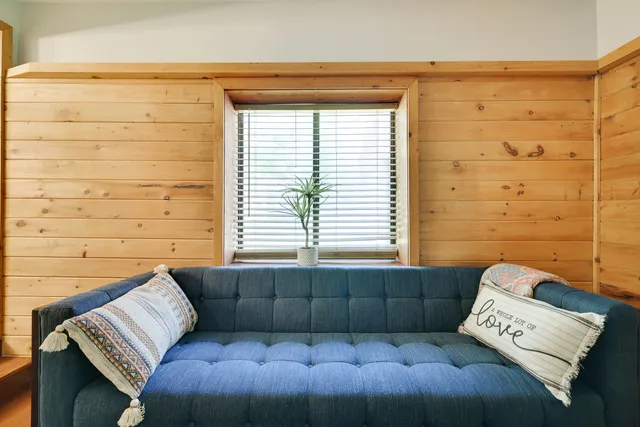 a view of a bedroom with a bed and a window