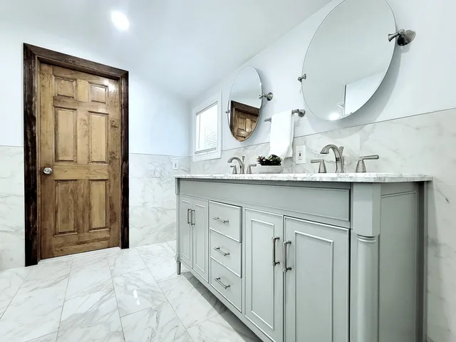 a bathroom with a sink vanity and mirror