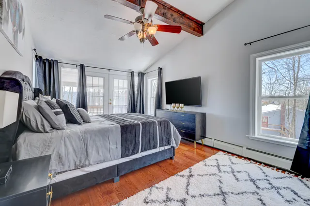a bedroom with a bed and flat screen tv