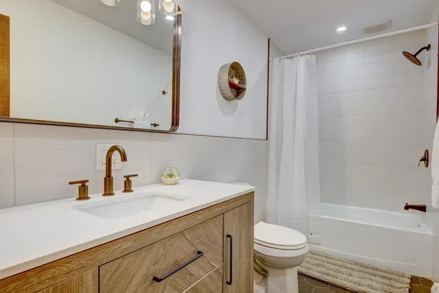 a bathroom with a sink a toilet and a bathtub