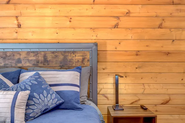 a bedroom with a bed and a lamp