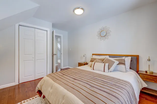 a bedroom with a bed and chair