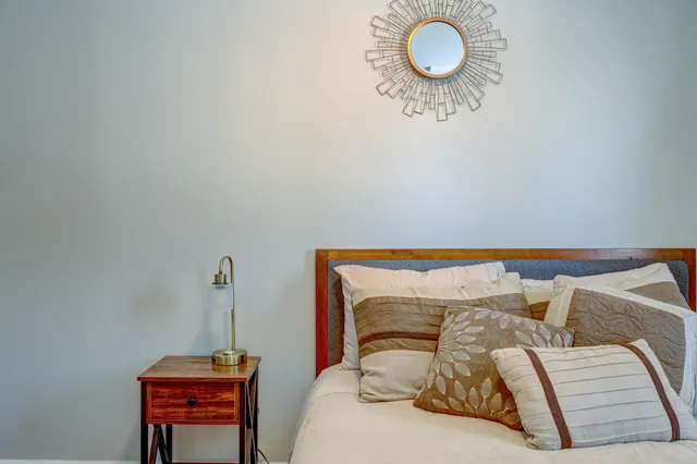 a room with pool table and wooden floor