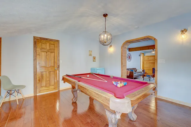 a room with pool table and windows