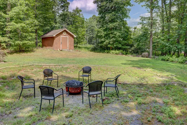 an aerial view of a house with yard and deck