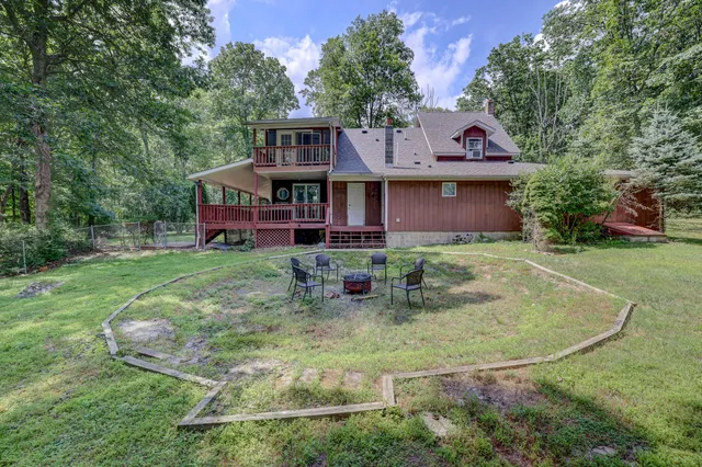 a view of a house with a snow in the yard