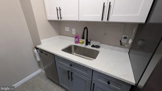 a utility room with sink dryer and washer