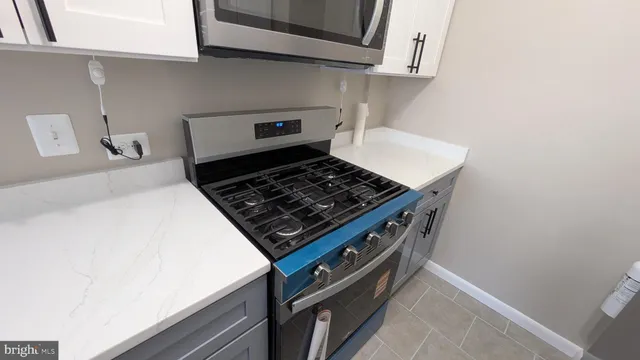 a stove top oven sitting inside of a kitchen
