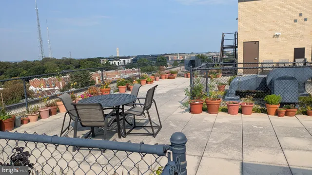 a terrace with outdoor seating and city view
