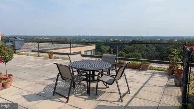 a view of dinning table and chairs in the balcony