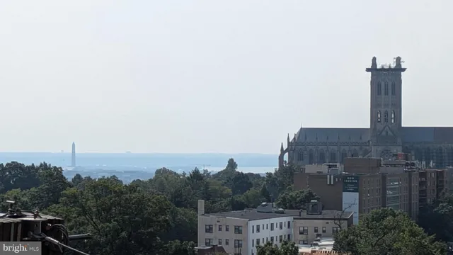 a aerial view of a house with a yard and mountain view in back