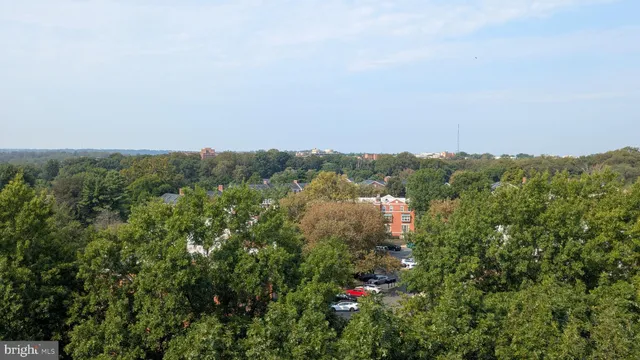 a kitchen with stainless steel appliances a sink a stove and white cabinets