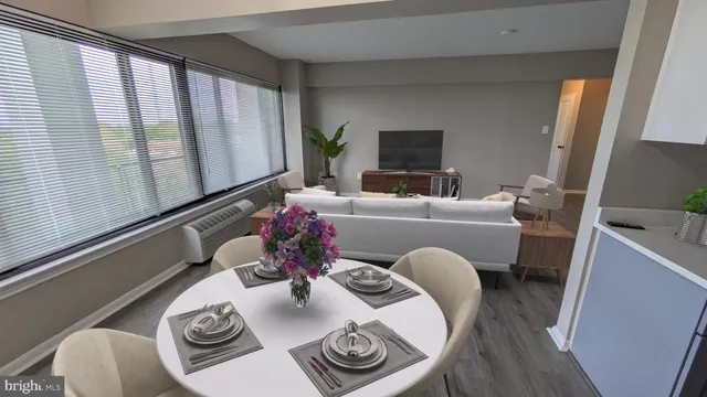 a living room with furniture and a floor to ceiling window