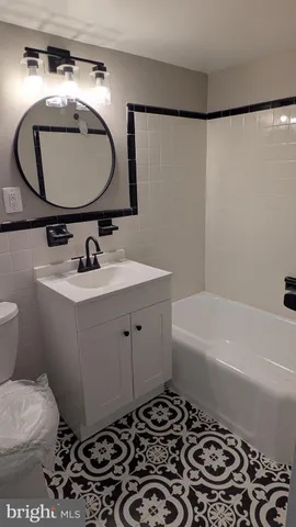 a bathroom with a sink toilet and a mirror