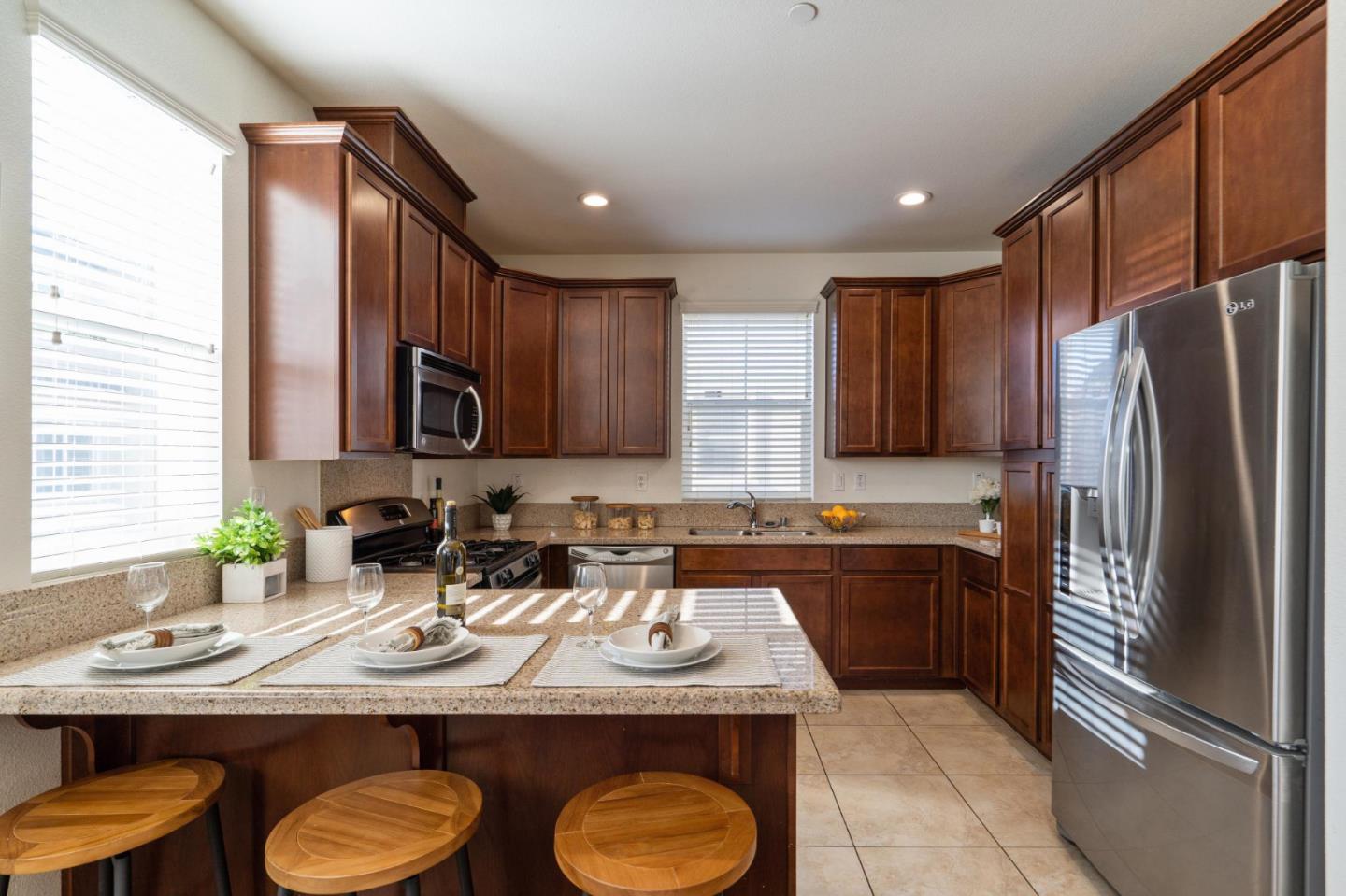 650 Macabee Way Hayward, CA 94541 - Photo 24 of 73 a kitchen with stainless steel appliances granite countertop a sink and a refrigerator