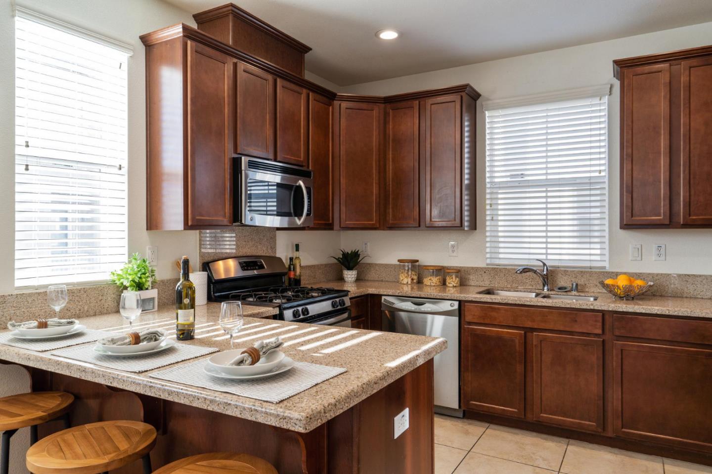650 Macabee Way Hayward, CA 94541 - Photo 25 of 73 a kitchen with a sink a stove a microwave cabinets and a counter top space