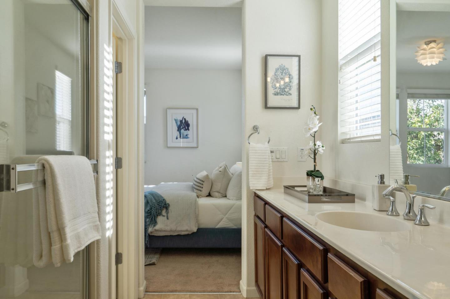 650 Macabee Way Hayward, CA 94541 - Photo 46 of 73 a en suite bathroom with a granite countertop sink and a mirror