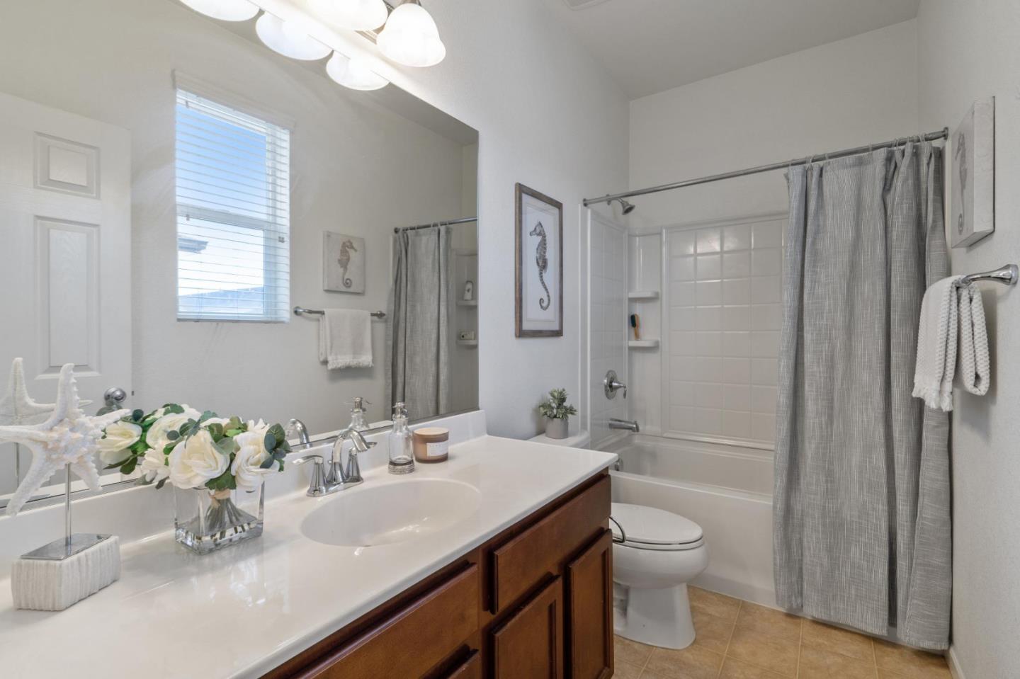 650 Macabee Way Hayward, CA 94541 - Photo 56 of 73 a bathroom with a granite countertop sink a toilet and shower