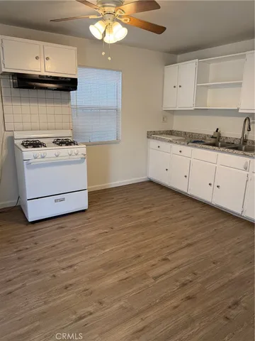 a view of washer and dryer with wooden floor