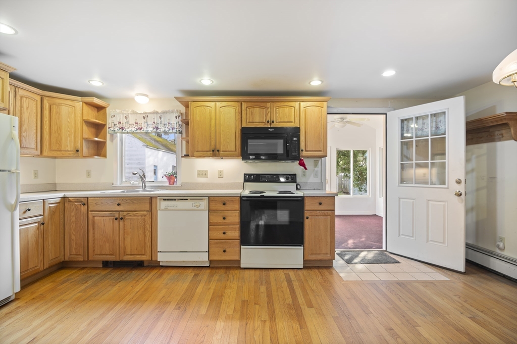 110 Linden Street Hamilton, MA 01982 - Photo 6 of 25 a kitchen with stainless steel appliances granite countertop a stove a sink and a refrigerator