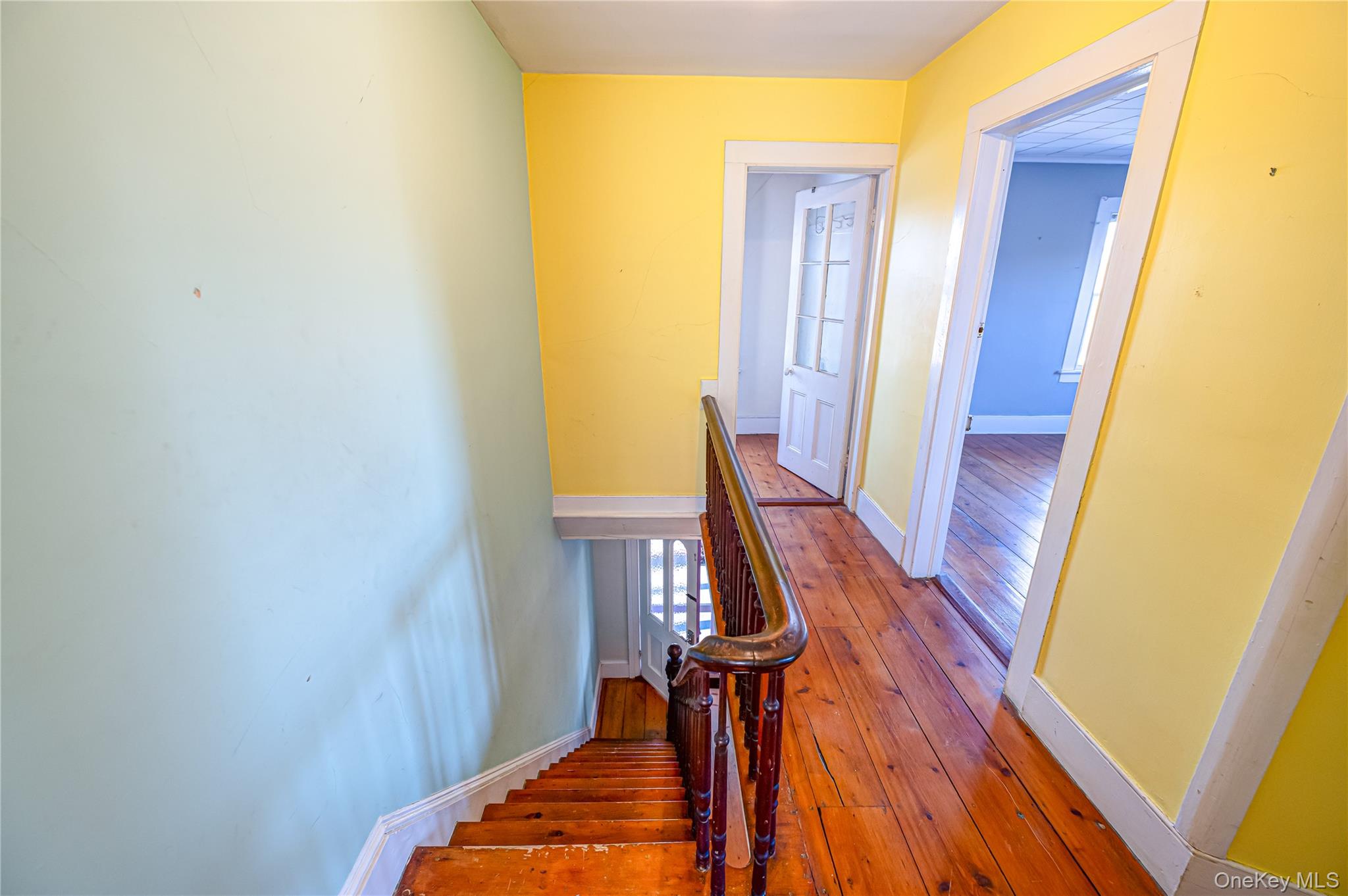 179 G Springville Road Hampton Bays, NY 11946 - Photo 15 of 45 Staircase with wood-type flooring and baseboards