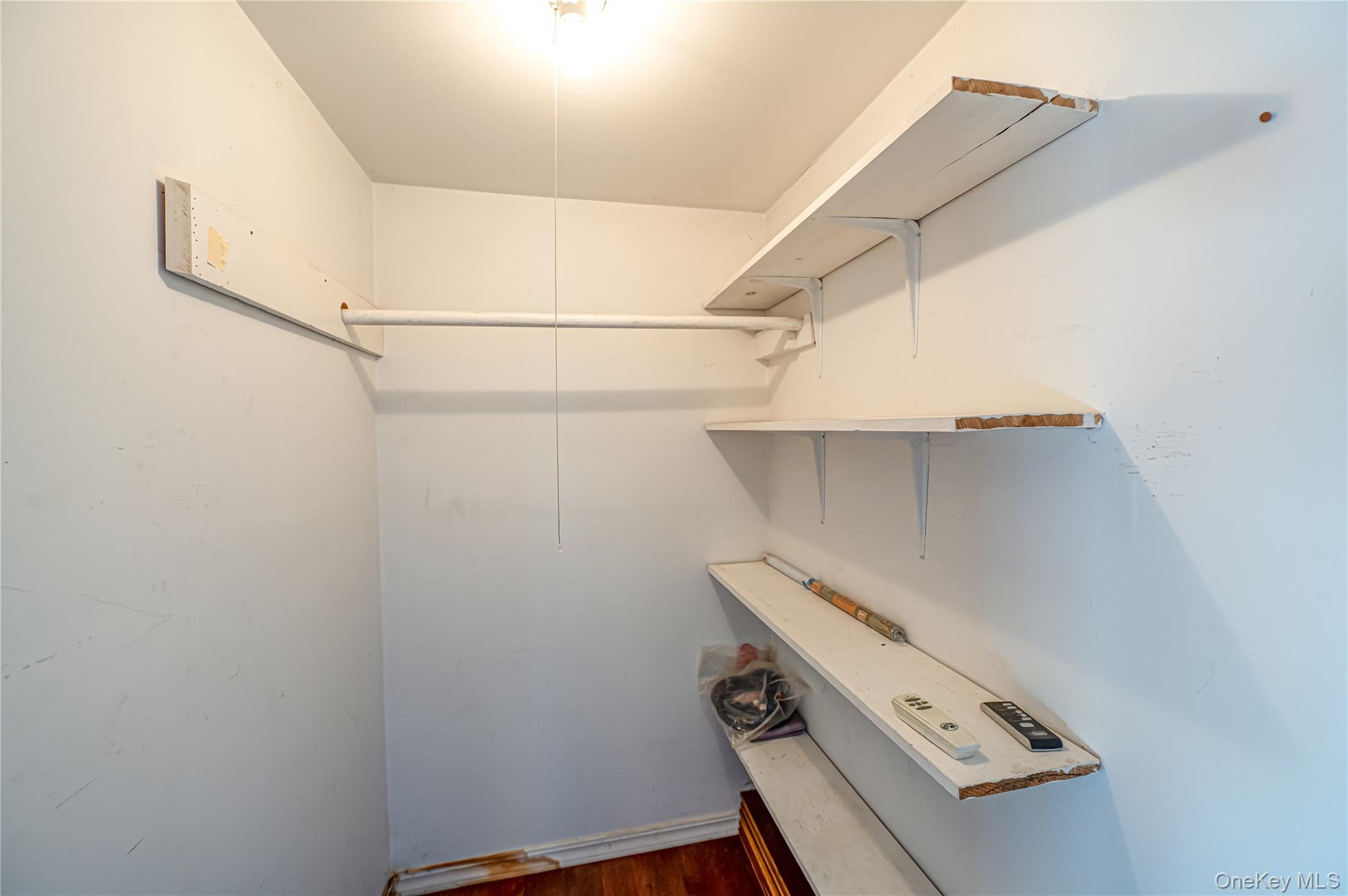 179 G Springville Road Hampton Bays, NY 11946 - Photo 20 of 45 Walk in closet with dark wood-type flooring