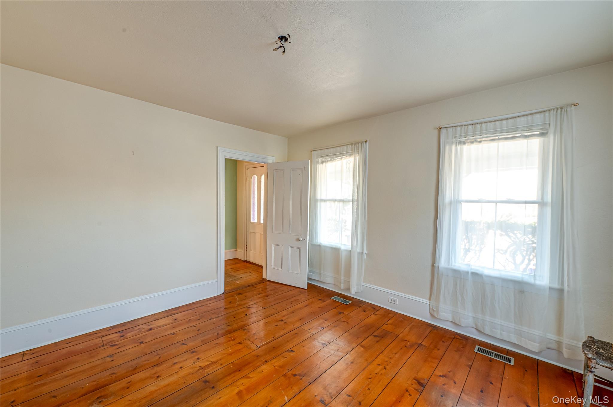 179 G Springville Road Hampton Bays, NY 11946 - Photo 27 of 45 Spare room with baseboards and hardwood / wood-style flooring