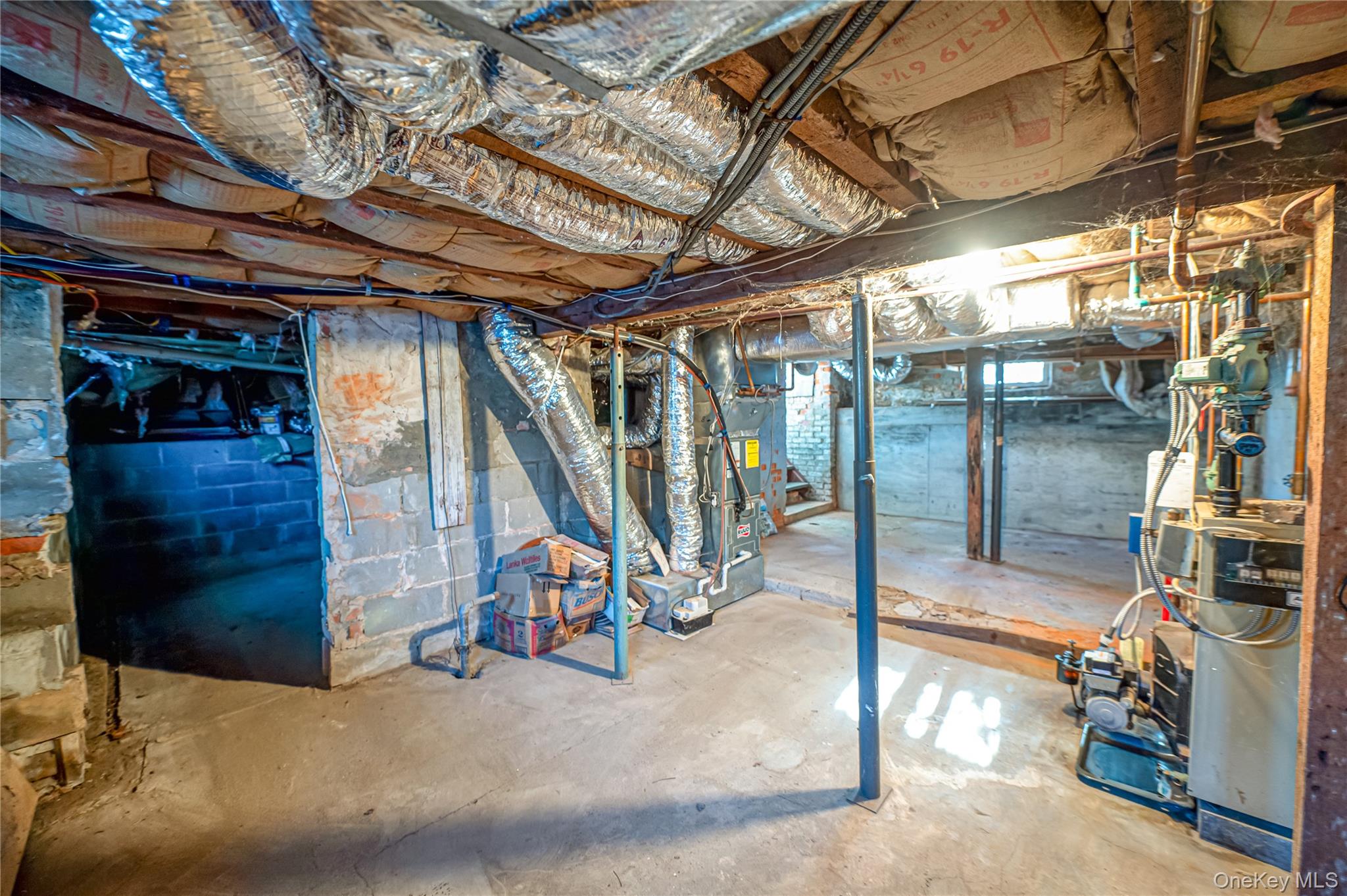 179 G Springville Road Hampton Bays, NY 11946 - Photo 39 of 45 Unfinished basement featuring a heating unit and heating unit