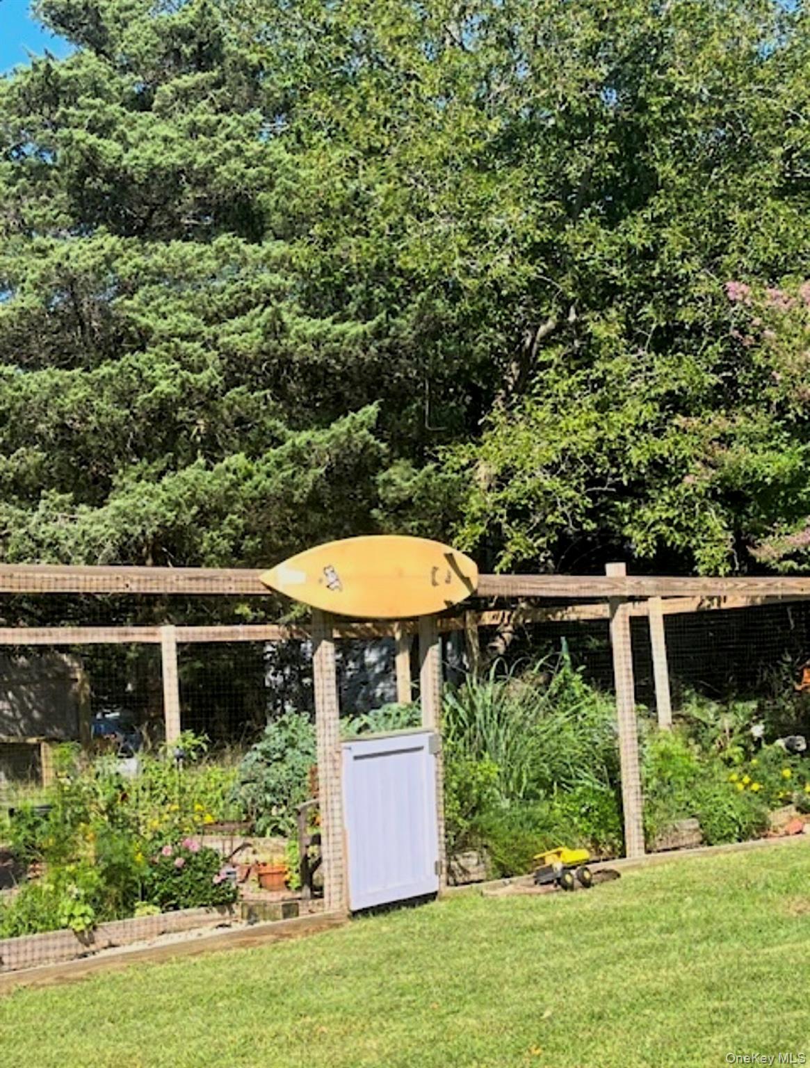 179 G Springville Road Hampton Bays, NY 11946 - Photo 42 of 45 View of grassy yard featuring a garden