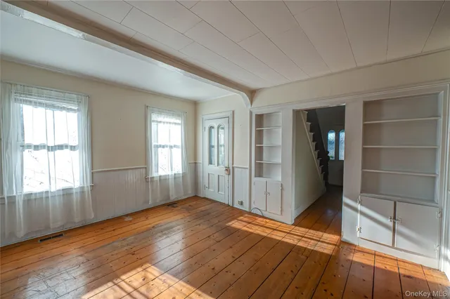 a view of a living room a window and wooden floor