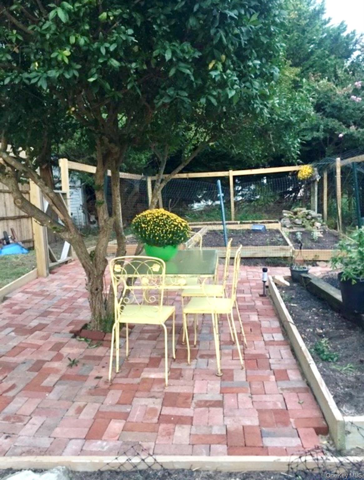 179 G Springville Road Hampton Bays, NY 11946 - Photo 10 of 45 Fenced backyard featuring a garden and a patio area