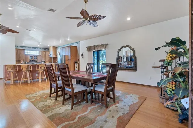 a bedroom with a bed and dresser with mirror