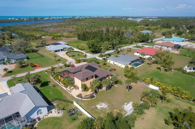 an aerial view of a house with a garden and lake view