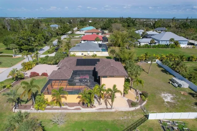 an aerial view of a house with a yard