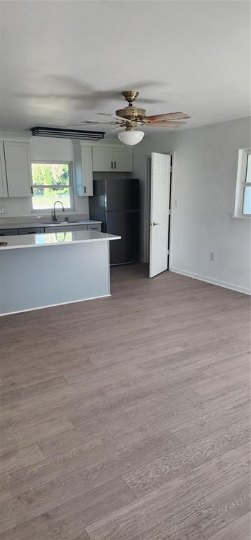390 Clark Street Deltona, FL 32725 - Photo 2 of 10 wooden floor in an empty room with a window