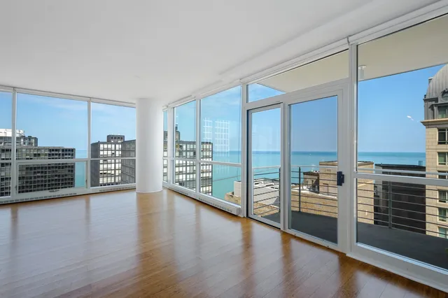 a view of a large kitchen with wooden floor and a window