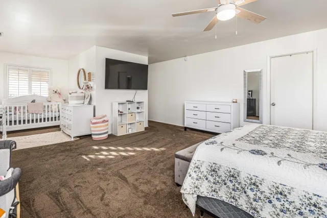 a bedroom with a bed and a dresser