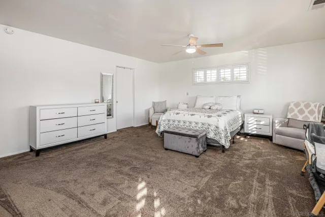 a spacious bedroom with a bed and a window