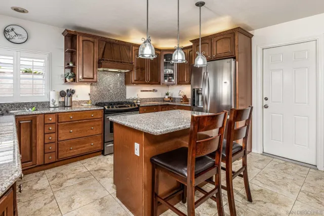 a kitchen with a table chairs refrigerator and microwave