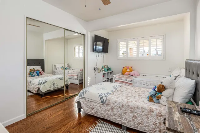 a bedroom with a bed and wooden floor