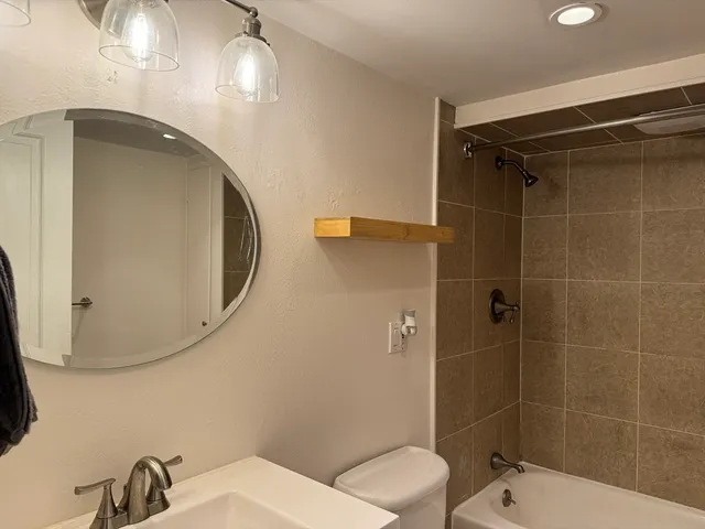 a bathroom with a toilet and a mirror