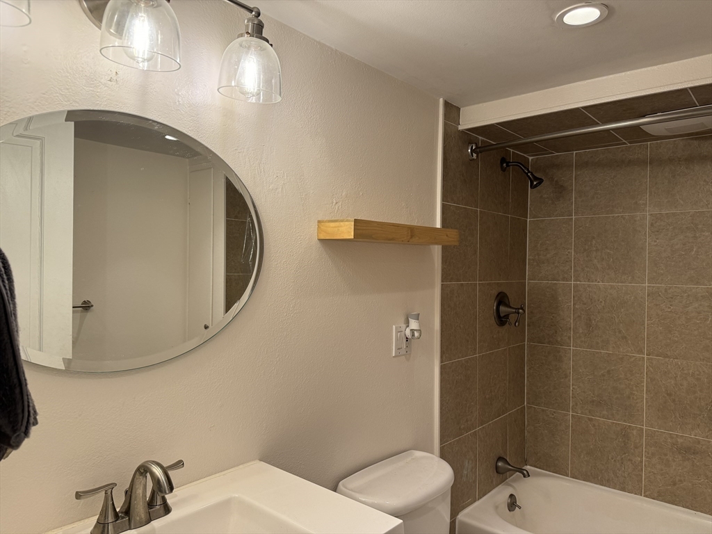 519 Columbus Avenue, Unit 1 Boston, MA 02118 - Photo 8 of 10 a bathroom with a toilet and a mirror