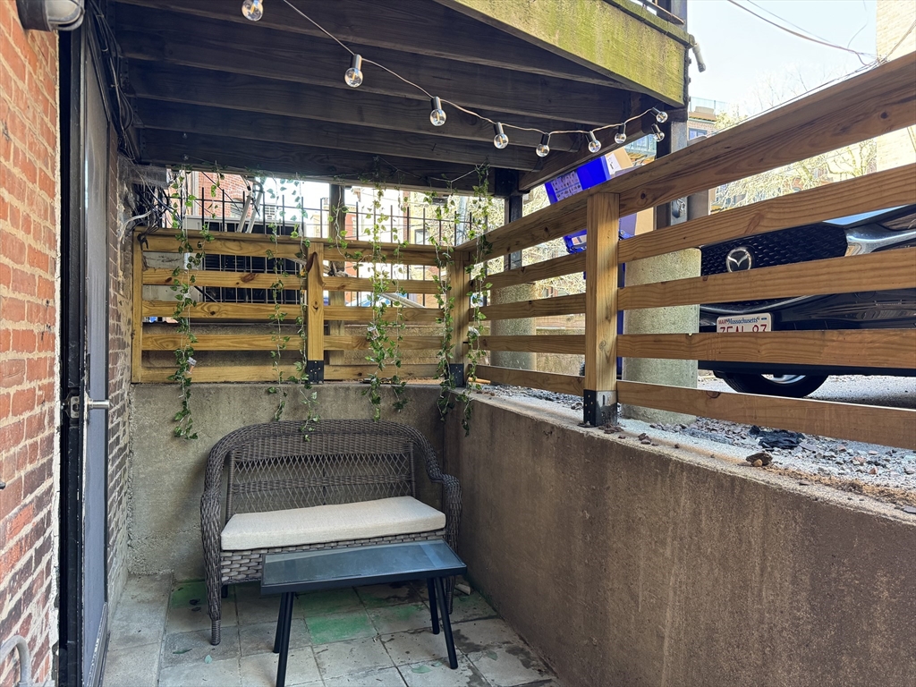519 Columbus Avenue, Unit 1 Boston, MA 02118 - Photo 9 of 10 a room with lots of wooden furniture and a window