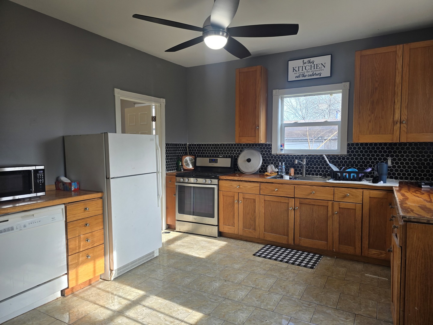 212 North Hunt Street Melvin, IL 60952 - Photo 13 of 43 a kitchen with a refrigerator a stove a sink a counter space and cabinets
