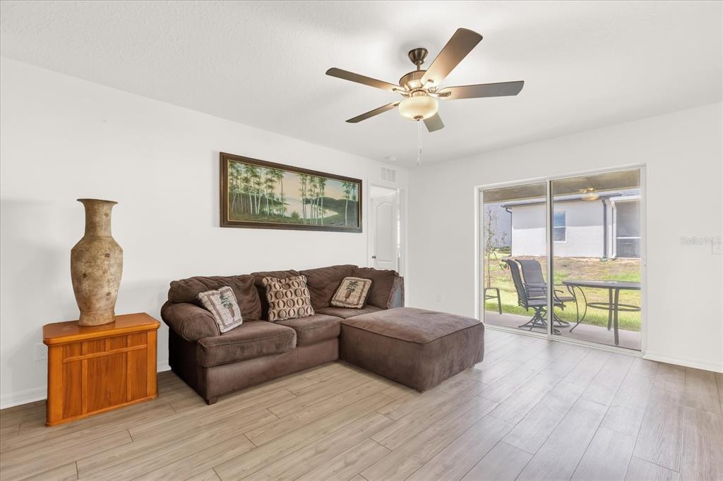 2134 Rio Grande Canyon Loop Poinciana, FL 34759 - Photo 6 of 22 a living room with furniture and wooden floor